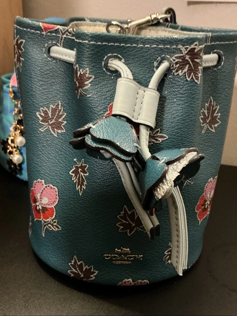 Coach Teal Floral Mini Drawstring Bucket Bag (rim has wear)